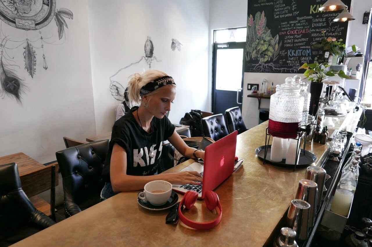 Lady works at laptop in coffee shop