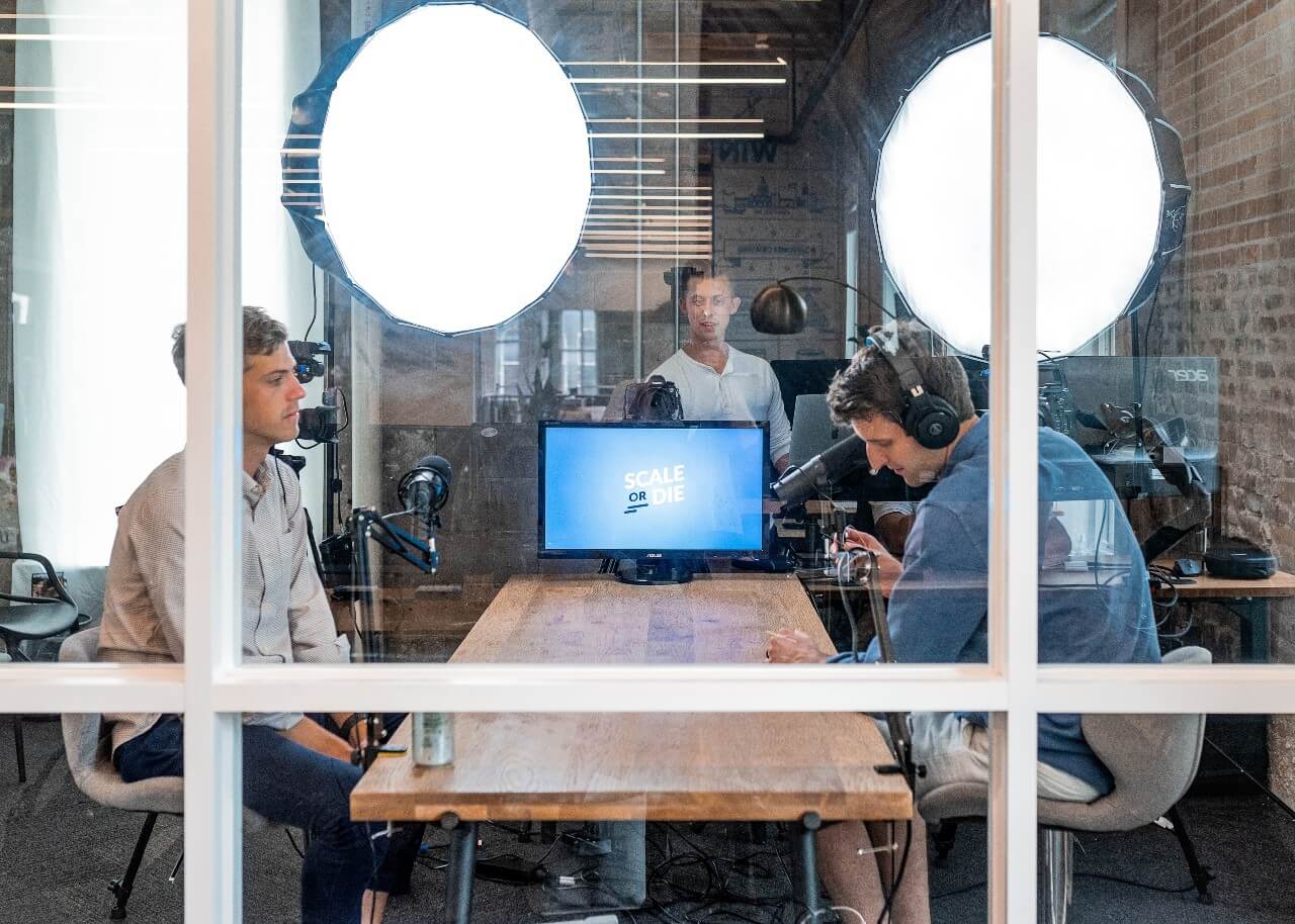 Two colleagues work at a computer together in an office