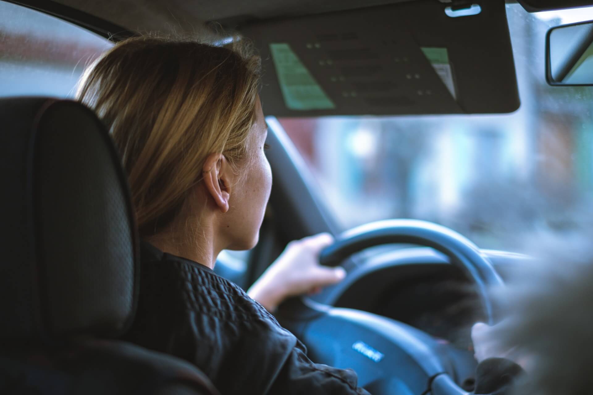 Mileage allowance relief header - image shows white woman with blonde hair wearing a black jacket driving a car