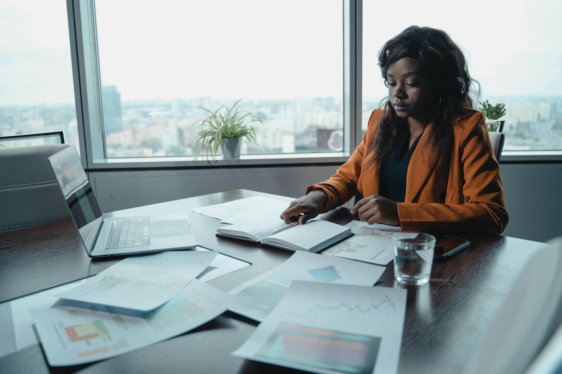 female company director sitting at a table planning her business.