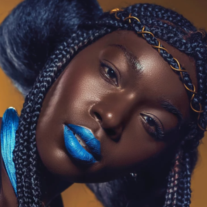 Model wearing blue lipcolour and braids. Image from a campaign by NL PR