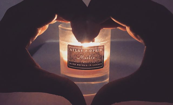 ATLAS+OPHIR candle with hands in a heart shape